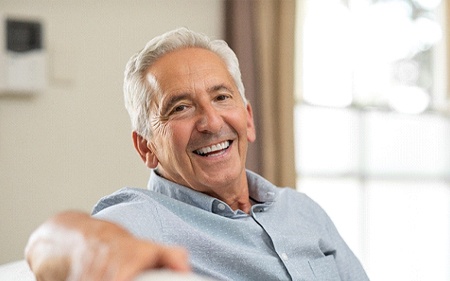 Laughing senior man with healthy teeth after full mouth reconstruction