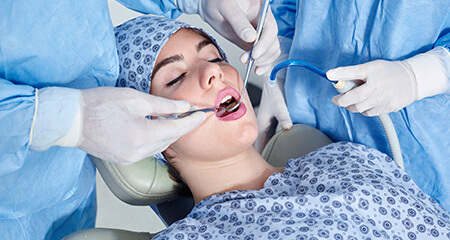 Relaxed patient receiving dental care under I V sedation dentistry