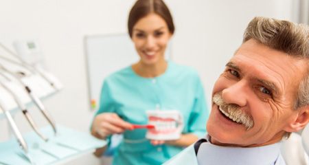 An older man who’s just received dentures