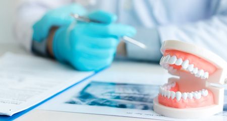 Dentures being held in the hand of a dentist