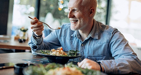 Man eating a chicken salad