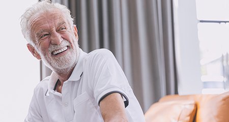 Dentures:Man holding a toothbrush with toothpaste