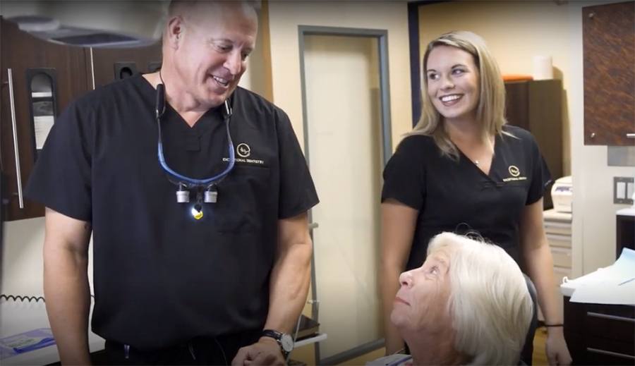Gainesville dentist and dental team member talking to patient