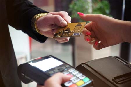 Man handing woman credit card