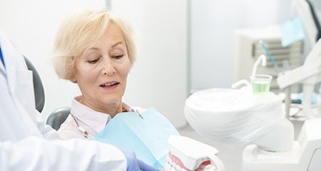 An older woman learning about the cost of dentures in Gainesville