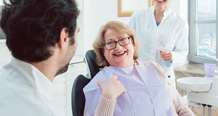 Denture dentist in Gainesville speaking with a patient