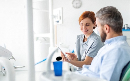 Dental professional and patient discussing full mouth reconstruction