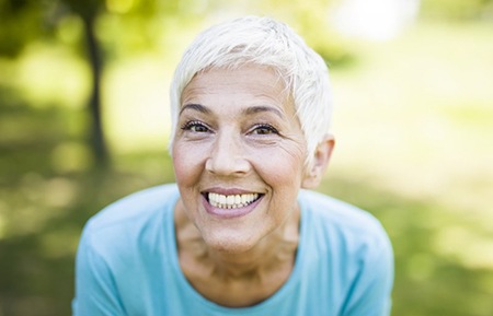 woman with dental implants in Gainesville showing off her smile 