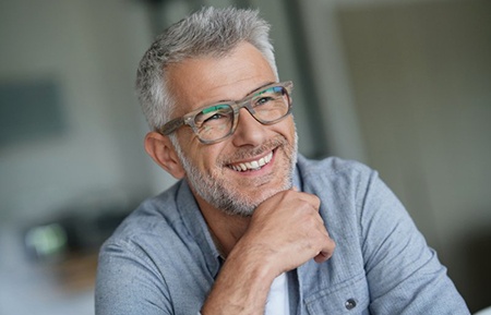man with glasses smiling 