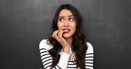 woman biting her fingernails