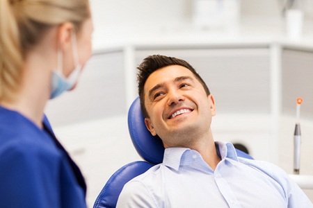 man talking with an implant dentist in Gainesville about the process