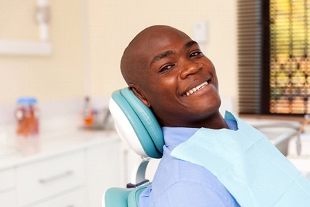 man smiling and enjoying the benefits of implant dentures in Gainesville