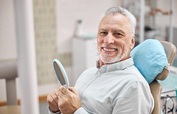 man smiling after getting dental implants