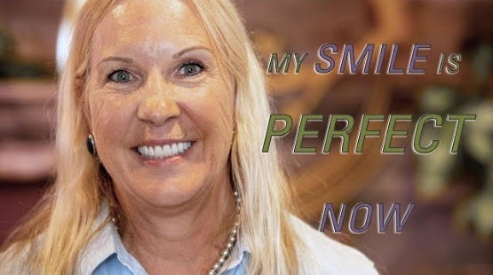 Gainesville dental patient grinning with text that says my smile is perfect now