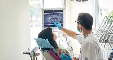 dentist showing a patient their X-rays during Invisalign consultation