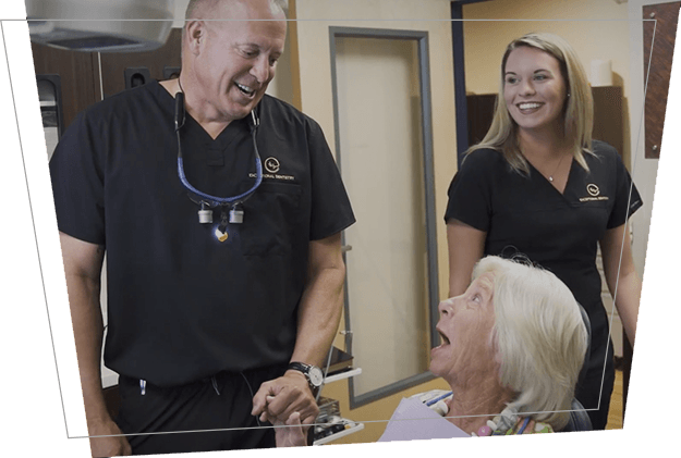 Dentist shaking hands with dental patient