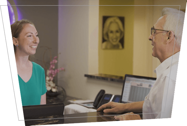 Smiling dental patient checking out