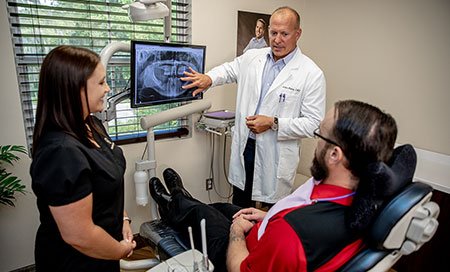 Dentist and patient looking at x-rays - Gainesville, Fl