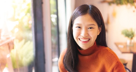 person smiling after porcelain veneer treatment