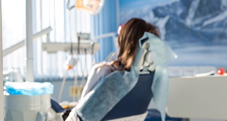 Woman relaxing in dentist's treatment chair