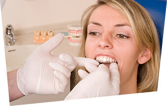 Dentist checking fit of Invisalign tray