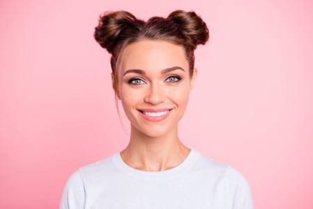 young woman smiling after getting smile makeover in Gainesville 