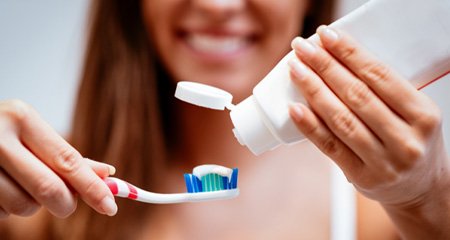 Woman holding toothbrush