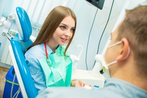 woman speaks to dentist