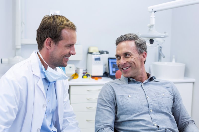 man consulting dentist about smile makeover in Gainesville