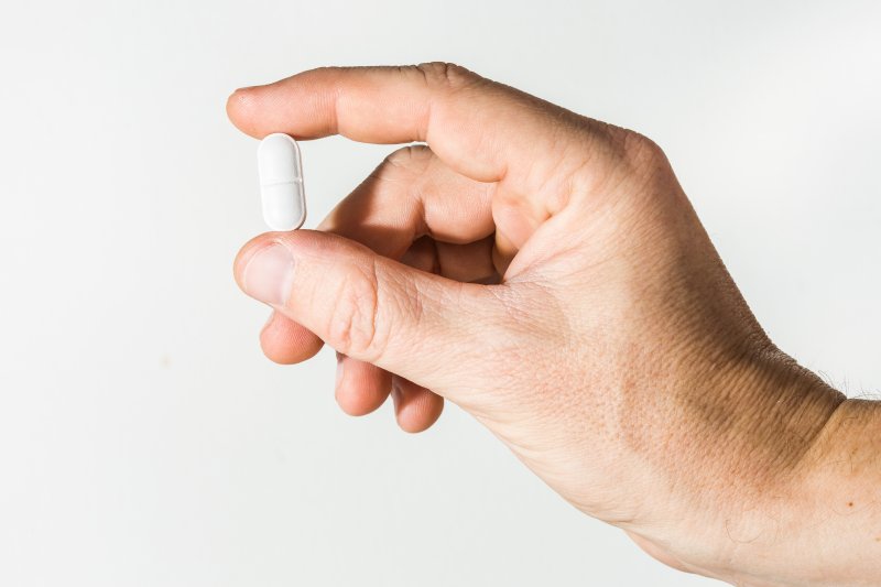 closeup of someone holding a pill