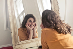 Woman looking at her teeth in a mirror