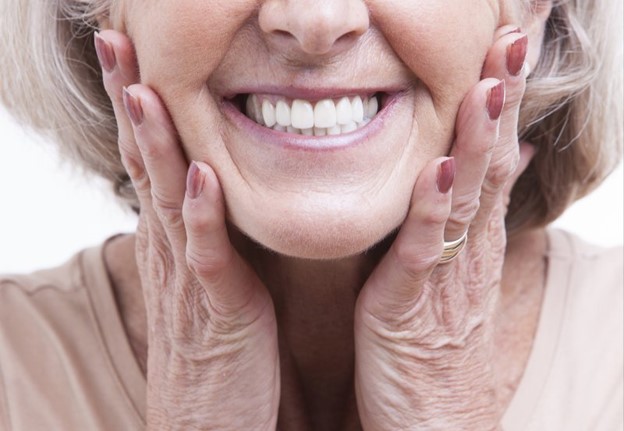 older person with dental implants smiling