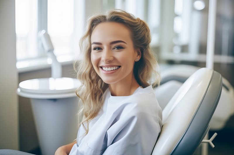 a woman smiling after receiving veneers